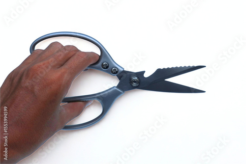 Hand holding Meat Scissors on white background photo