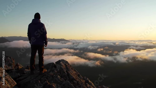 Man on mountaintop at sunrise