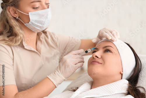 Female beautician giving in...