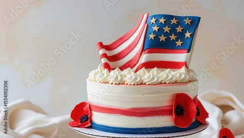 Patriotic cake decorated with an american flag and red poppy flowers on a white fabric background