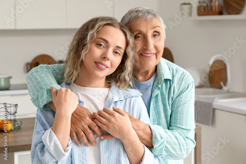 Senior woman hugging her gr...
