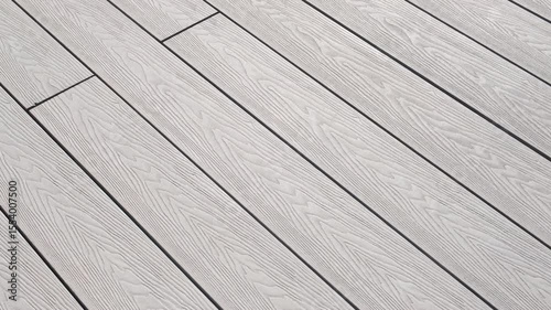 Close-up of light gray composite decking with pronounced wood texture. The surface appears modern and neat, perfect for outdoor relaxation areas and stylish architectural solutions
