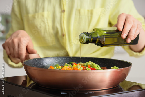 Woman with olive oil frying...