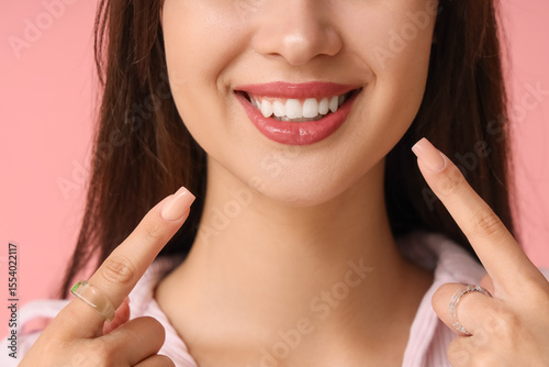 Young woman pointing at her...