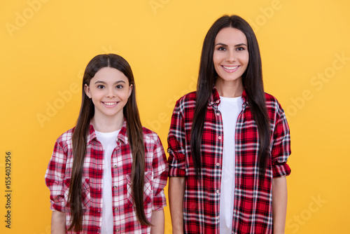 Mother and daughter posing in studio. Girls family. Happiness with daughter. Happy mother and daughter portrait on isolated background. Female family. Mother and daughter happy face.