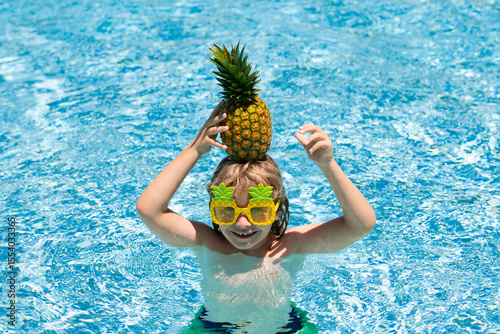 Summer vacation. Cute kid in swimming pool. Children play in tropical resort. Family beach vacation and summer activity.
