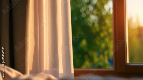 Morning sunlight streaming through a curtain, illuminating a cozy bedroom with greenery outside
