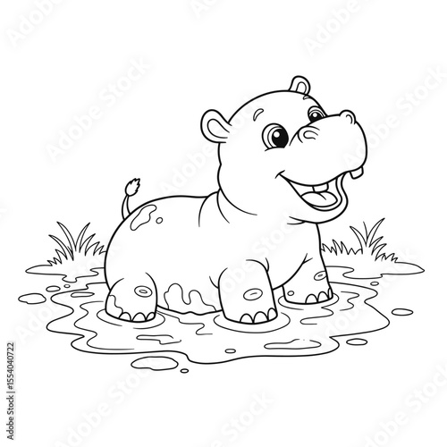 A muddy baby hippopotamus grins widely while standing in a puddle among grass.