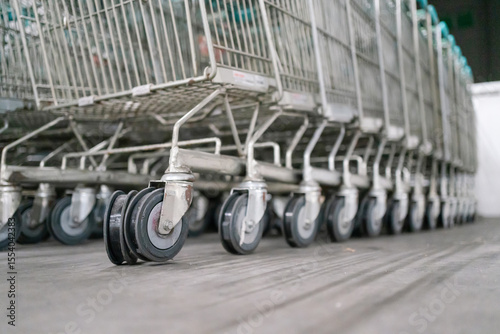 Close-up shot of shopping cart wheels with worn-out rubber, stacked together in a storage area.