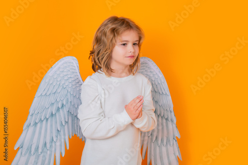 Angel prayer kids. Valentines day banner. Cute child with angel wings. Studio portrait of angel child on studio color isolated background with copy space.