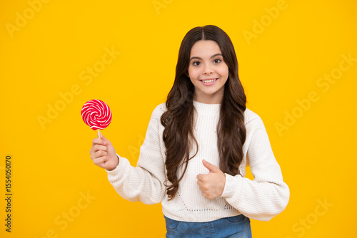 Teenager girl with caramel candies on sticks, sweet sugar addiction. Child with lollipops. Happy face, positive and smiling emotions of teenager girl.