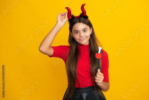 Kid with pumpkin. Halloween witch girl. Teen witch. Kid girl witch celebrates Halloween. Happy Halloween. Portrait of an Halloween child teenager girl. Seasonal autumn sale.