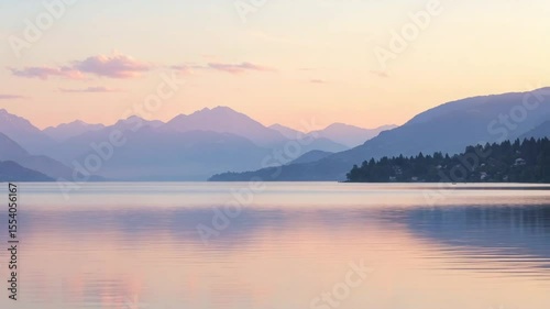 Serene mountain lake at sunset with soft reflections and colors