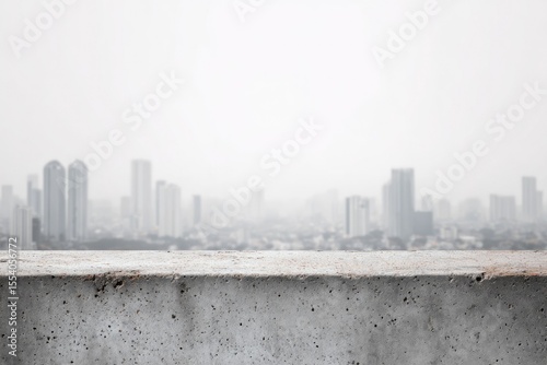 Hazy cityscape viewed from a weathered concrete ledge