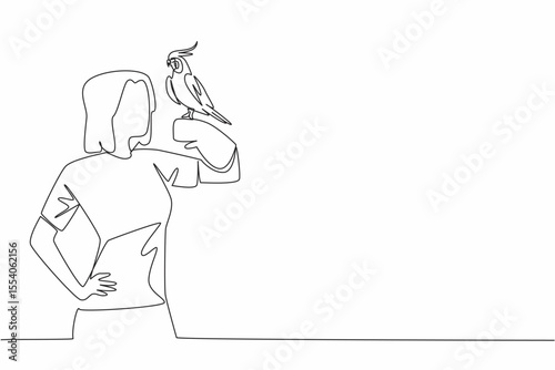 Single one line drawing grey cockatiel perched on hand of woman. Bird with characteristic crest on its head. A gentle and loving animal. Woman Holding Bird. Continuous line design graphic illustration