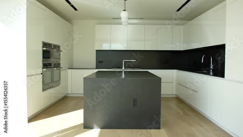 Bright, Minimalist Modern Kitchen Interior with White Cabinets, Dark Island, and Wood Floor Design
