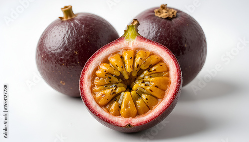 Passion fruit displays its juicy pulp alongside two whole fruits, set against a clean white background, creating a fresh and appetizing tropical still life.