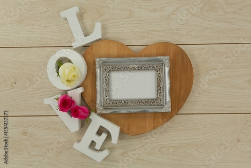 Photo frame with love alphabet on table