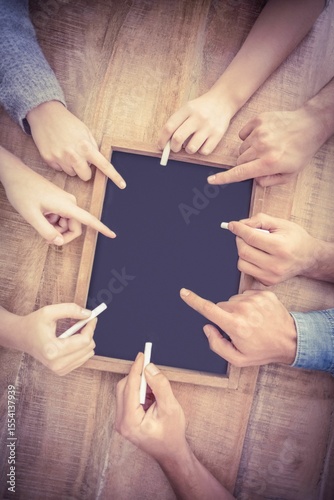 Hands writing on chalkboard