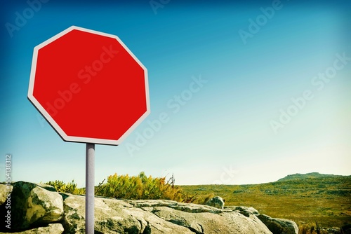 Red road sign by mountain trail