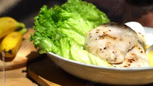 Grilled chicken salad with bananas and vegetable salad. Grilled chicken breast, fillet and fresh vegetable salad of lettuce. Healthy lunch menu. Diet food.