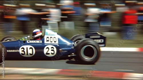 Vintage Formula One Race Blue and Gold Race Car Speeding on Track