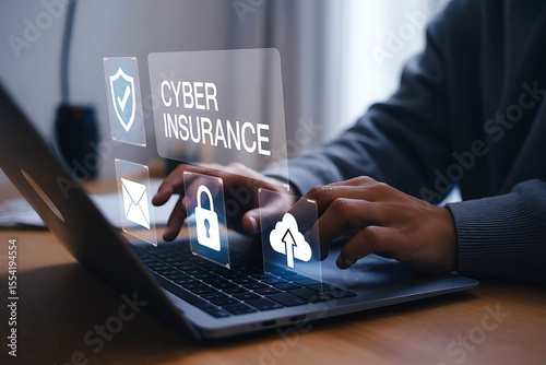 Person using laptop computer with cyber insurance interface