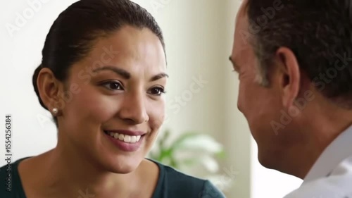 Smiling woman attentively listening and engaging in positive conversation with a man, conveying trust and connection