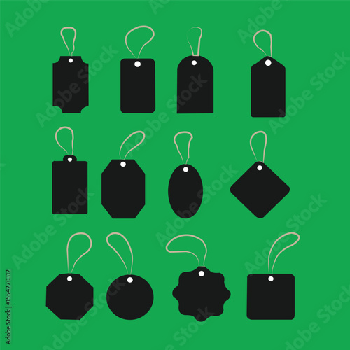 Assortment of Black Price Tags with Strings on a Green Background