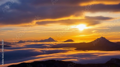 Golden sunrise over the sea with calm waves and clouds, warm scenic start of a peaceful morning on the horizon	