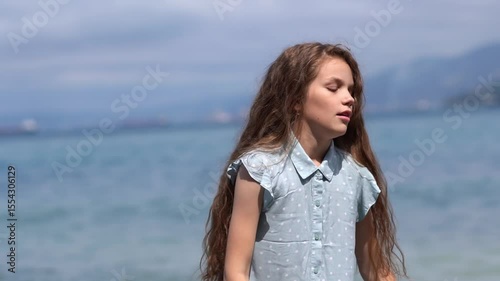 Portrait of happy smiling teenage girl on sunny day at beach