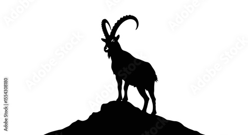Silhouette of a Majestic Goat Standing on Rocky Outcrop Against Bright Background