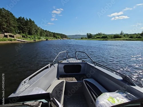 Wallpaper Mural Boat motor is on the water with a green bag on the side. The boat is on river Torontodigital.ca
