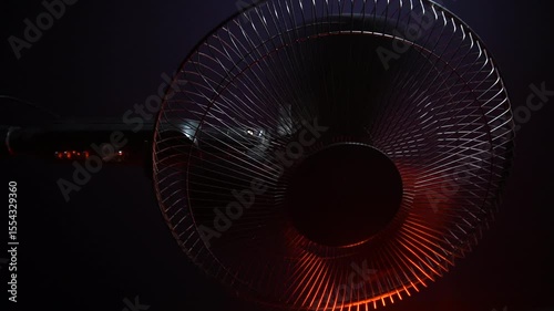 black home fan from the summer heat blowing fresh air in red backlight