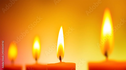Four flickering candles casting a warm glowing light as elegant home decor wall art or desktop background