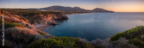 Stunning Andalusian coastline sunset photo with golden and reddish hues  
