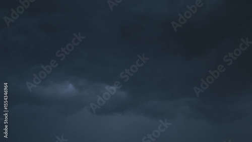 Dark clouds gather ominously over the horizon as evening approaches