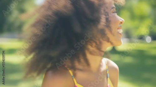Person enjoying sunny park with lush green background