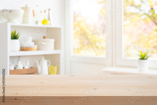 Wooden table top for presentation on blurred window and kitchen decoration products background