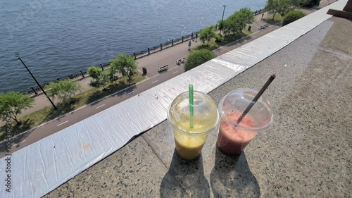 View of the embankment from a high terrace in a bar or cafe on the shore on a bright sunny day with cocktails or smoothies