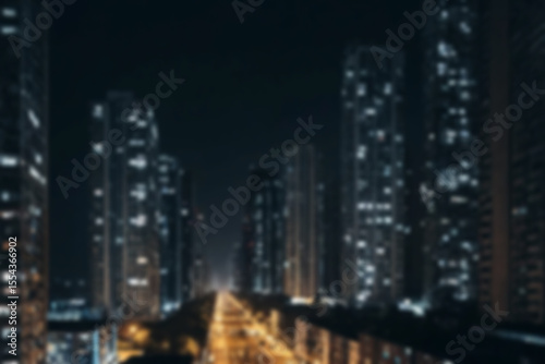 Blurry photo of city at night showing street lights and buildings with blur.