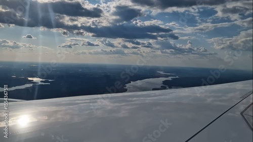 The view from the window of an air plane of clouds and blue sunny sky.