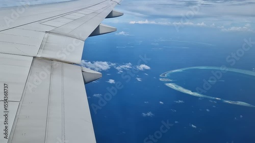 View from the airplane window to the Indian Ocean and the atoll. Maldives
