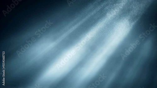 Ethereal blue volumetric light rays with sparkling dust particles shining through dark fog in a seamless loop