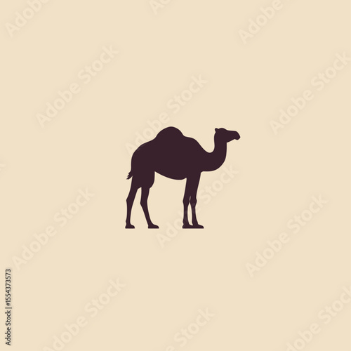 Silhouette of a dromedary camel standing set against a plain background