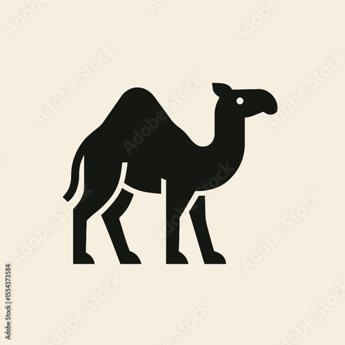Silhouette of a camel with a large hump standing against a light background