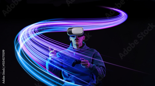 Obraz na płótnie Man using virtual reality headset and controller against black background. Bright neon lines near him