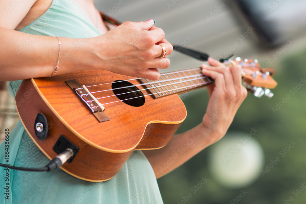 Fototapeta premium Girl rings ukulele in a show