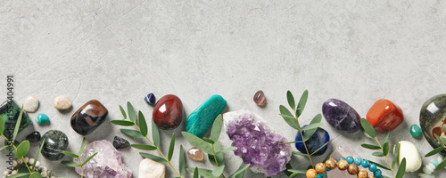 Border of Healing Crystals and Greenery on Concrete Surface
