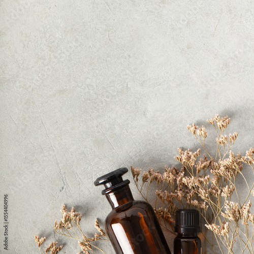 Aromatherapy Bottles, Crystals, and Dried Flowers on Gray Surface